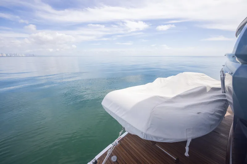 Seahawk Yacht Photos Pics Azimut Magellano 66 yacht deck with covered equipment, 2025 model, serene ocean view.