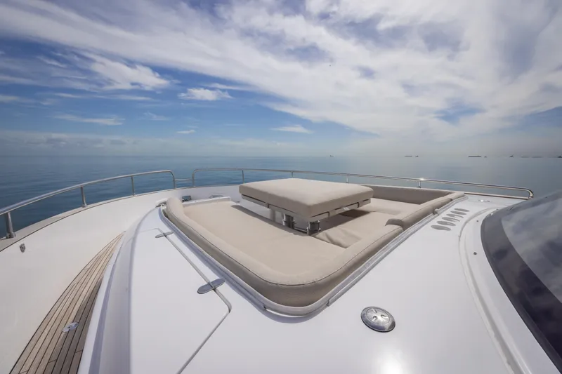 Seahawk Yacht Photos Pics Luxurious 2025 Azimut Magellano 66 yacht deck with sunbathing area, calm sea view.