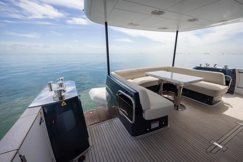 Seahawk Yacht Photos Pics Luxurious 2025 Azimut Magellano 66 yacht deck with elegant seating and ocean view.