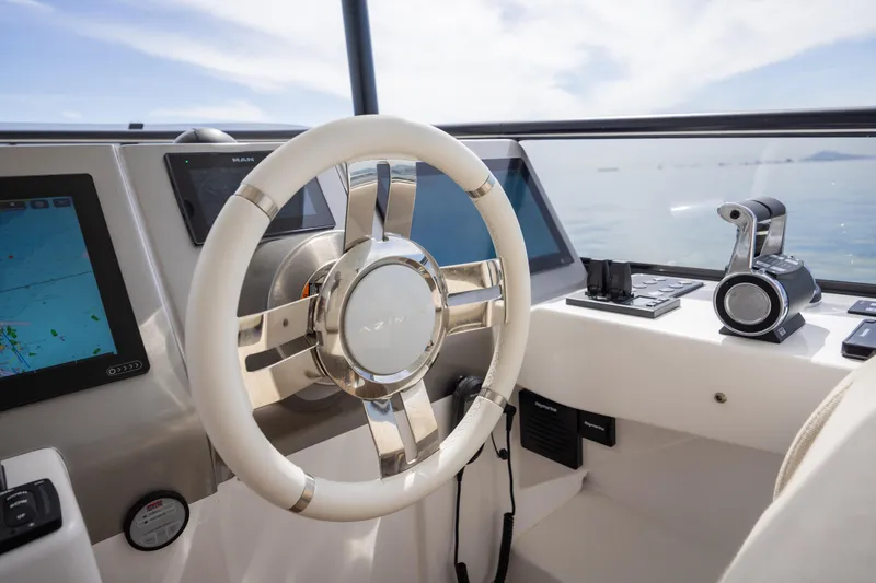 Seahawk Yacht Photos Pics 2025 Azimut Magellano 66 yacht helm with modern navigation controls and steering wheel.