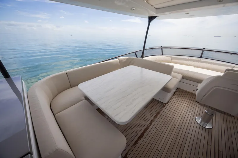 Seahawk Yacht Photos Pics Luxurious seating area on 2025 Azimut Magellano 66 yacht with ocean view.