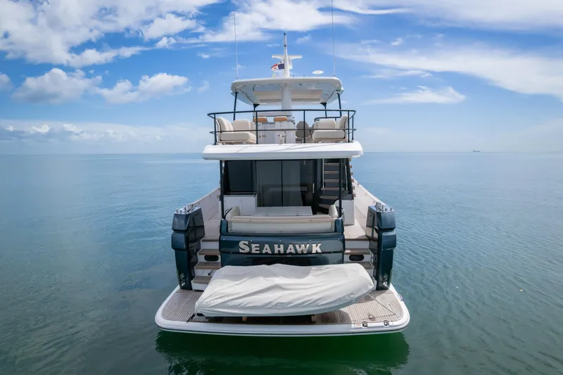 Seahawk Yacht Photos Pics 2025 Azimut Magellano 66 yacht "Seahawk" on calm ocean waters under blue sky.
