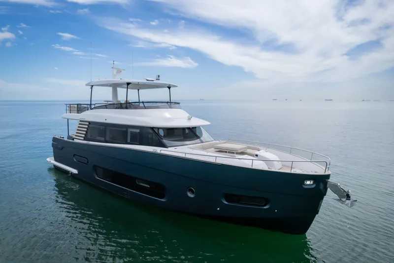 Seahawk Yacht Photos Pics 2025 Azimut Magellano 66 yacht cruising on calm ocean waters under a clear sky.