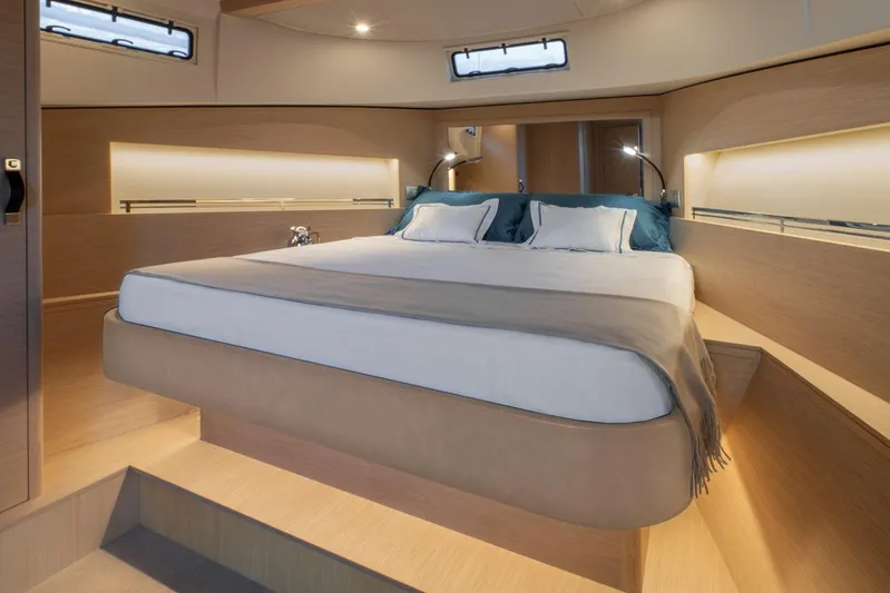  Yacht Photos Pics Luxurious interior of 2026 Solaris Power 44ST yacht with elegant bedding and ambient lighting.