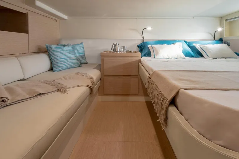  Yacht Photos Pics Luxurious interior of 2026 Solaris Power 44ST yacht with cozy bed and seating area.