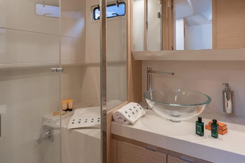  Yacht Photos Pics Luxurious bathroom in 2026 Solaris Power 44ST yacht with glass sink and modern amenities.