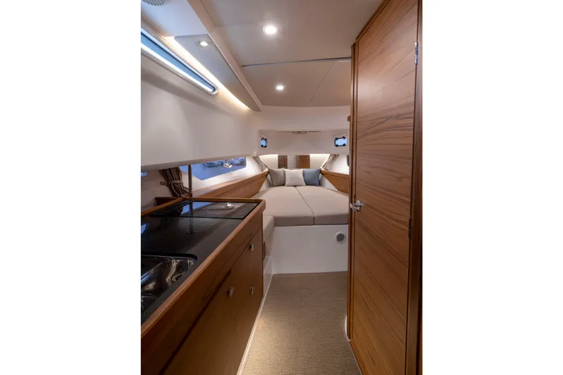  Yacht Photos Pics 2024 Nimbus C11 interior with modern wood finish and cozy sleeping area.