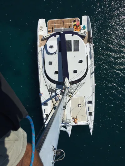 Sovereign Yacht Photos Pics Aerial view of 2006 Lidgard Custom Catamaran on clear blue water.