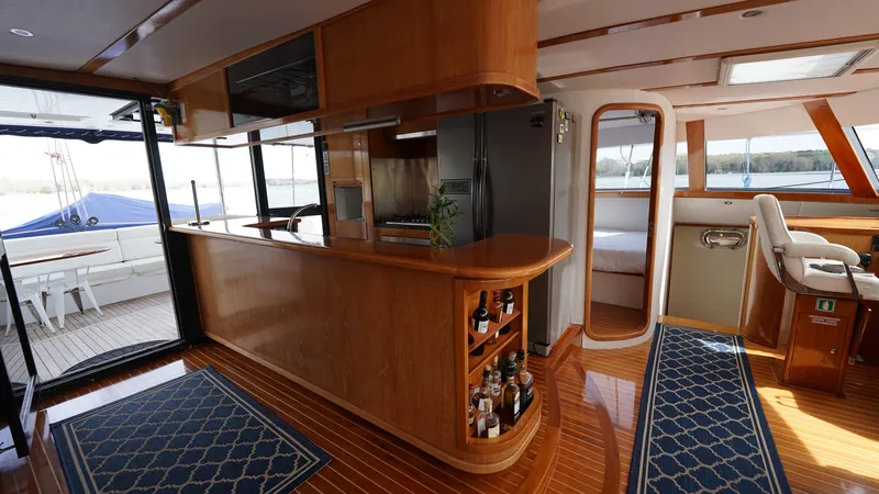Sovereign Yacht Photos Pics Luxurious 2006 Lidgard Custom Catamaran interior with wooden bar and modern amenities.