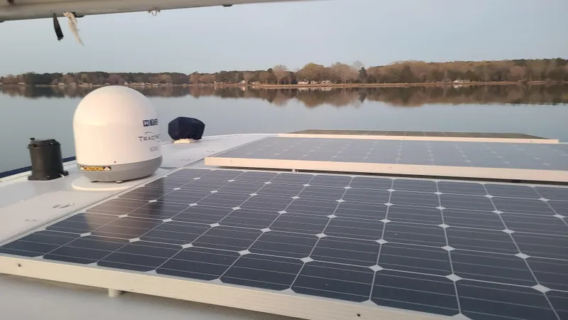 Sovereign Yacht Photos Pics Solar panels on 2006 Lidgard Custom Catamaran, reflecting serene lake view.