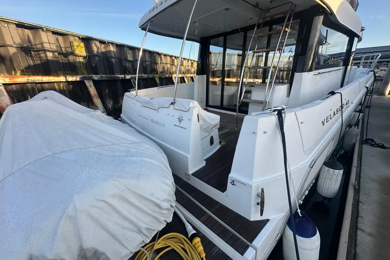 Couples Therapy Yacht Photos Pics 2014 Jeanneau Velasco 43 yacht docked, featuring sleek design and covered equipment.