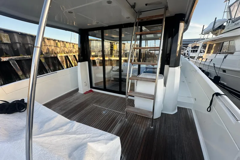 Couples Therapy Yacht Photos Pics 2014 Jeanneau Velasco 43 yacht deck with wooden flooring and ladder.