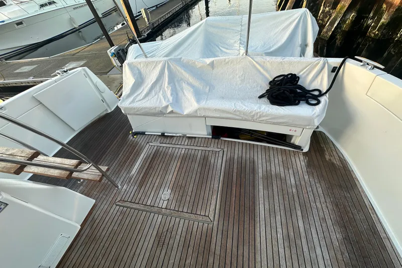 Couples Therapy Yacht Photos Pics 2014 Jeanneau Velasco 43 yacht deck with wooden flooring and covered seating area.