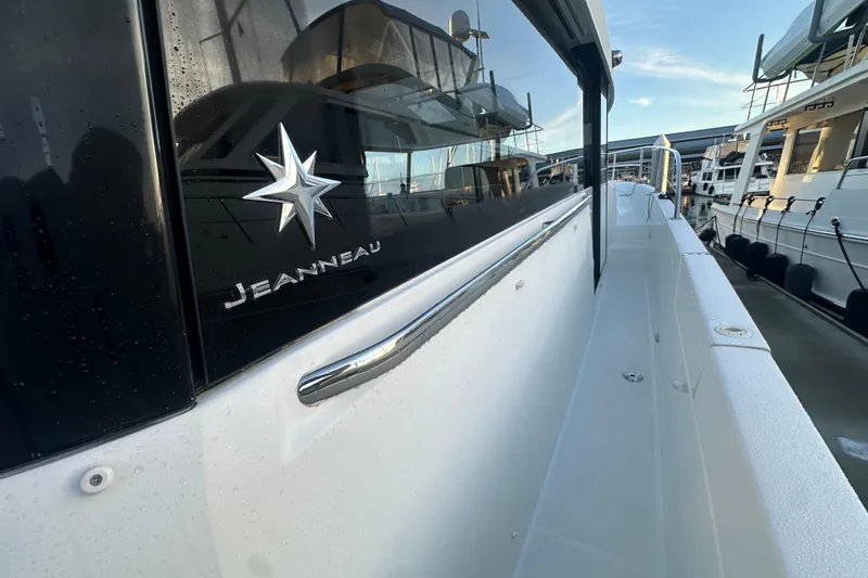 Couples Therapy Yacht Photos Pics 2014 Jeanneau Velasco 43 yacht docked, showcasing sleek design and branding.
