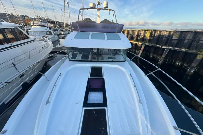 Couples Therapy Yacht Photos Pics 2014 Jeanneau Velasco 43 yacht docked at marina, showcasing sleek design and spacious deck.