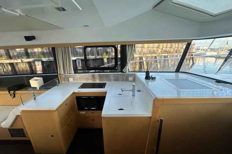 Couples Therapy Yacht Photos Pics Modern kitchen interior of 2014 Jeanneau Velasco 43 yacht with sleek countertops and appliances.