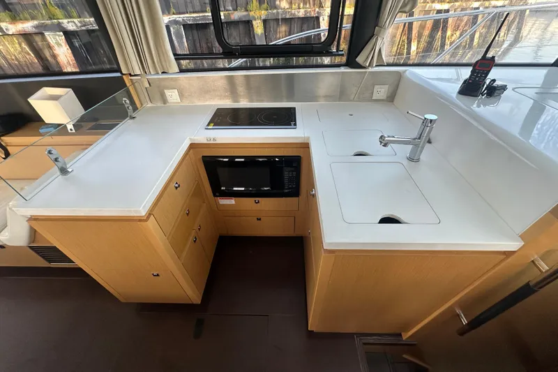Couples Therapy Yacht Photos Pics 2014 Jeanneau Velasco 43 yacht kitchen with stove, sink, and microwave.