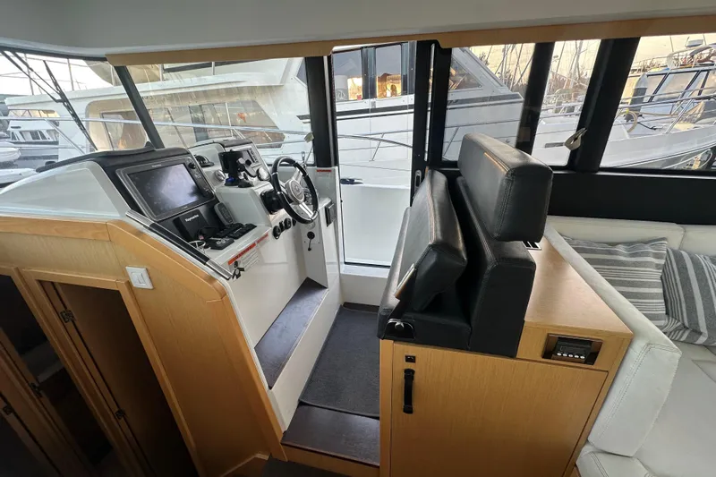 Couples Therapy Yacht Photos Pics Interior helm of 2014 Jeanneau Velasco 43 yacht with modern navigation equipment.