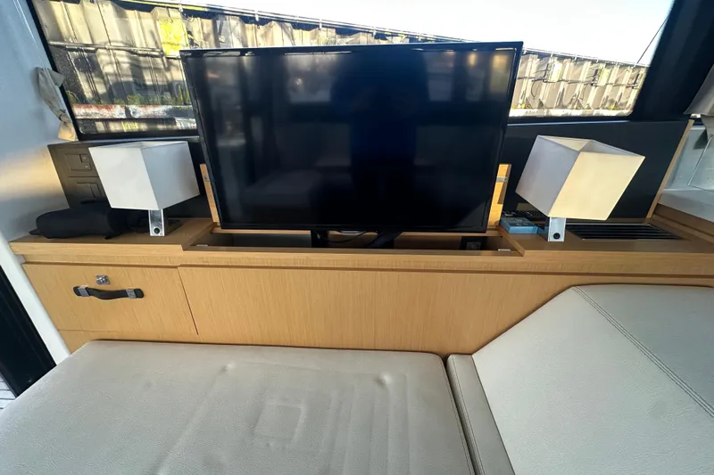 Couples Therapy Yacht Photos Pics Interior of 2014 Jeanneau Velasco 43 with TV and modern decor.