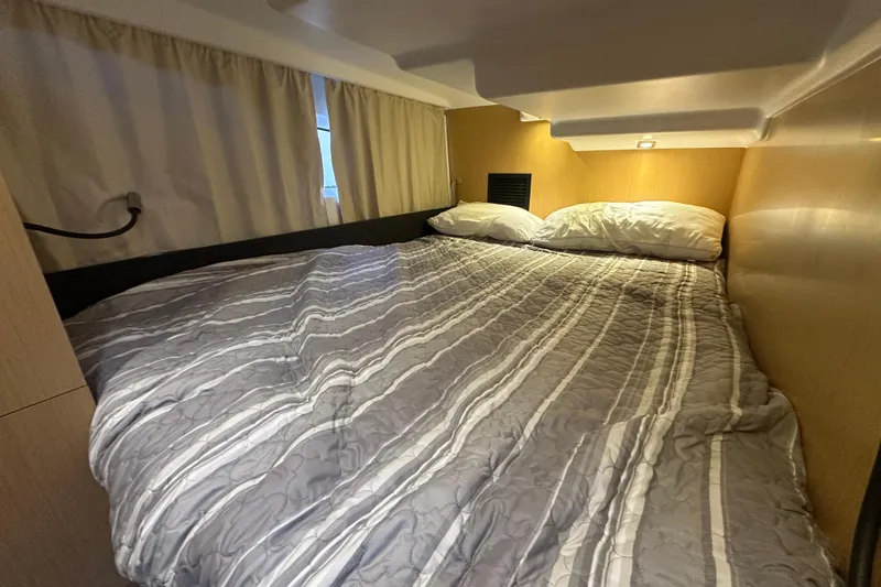 Couples Therapy Yacht Photos Pics Cozy cabin bedroom in 2014 Jeanneau Velasco 43 yacht with striped bedding.