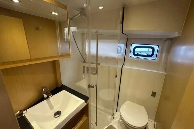 Couples Therapy Yacht Photos Pics Bathroom interior of 2014 Jeanneau Velasco 43 yacht, featuring sink, shower, and window.