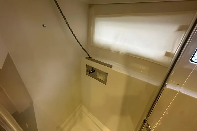 Couples Therapy Yacht Photos Pics Shower area in 2014 Jeanneau Velasco 43 yacht, featuring modern fixtures and natural lighting.