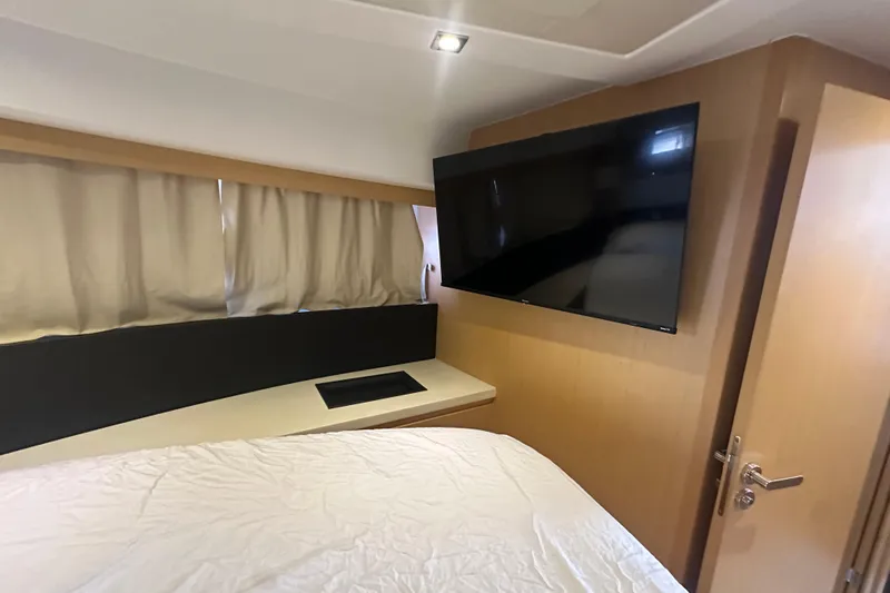 Couples Therapy Yacht Photos Pics Interior of 2014 Jeanneau Velasco 43 yacht with TV and bed.