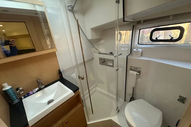 Couples Therapy Yacht Photos Pics Bathroom interior of 2014 Jeanneau Velasco 43 yacht with shower, sink, and toilet.