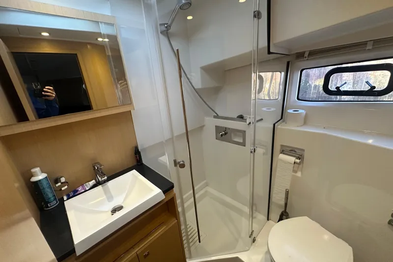 Couples Therapy Yacht Photos Pics Bathroom interior of 2014 Jeanneau Velasco 43 yacht with shower and sink.