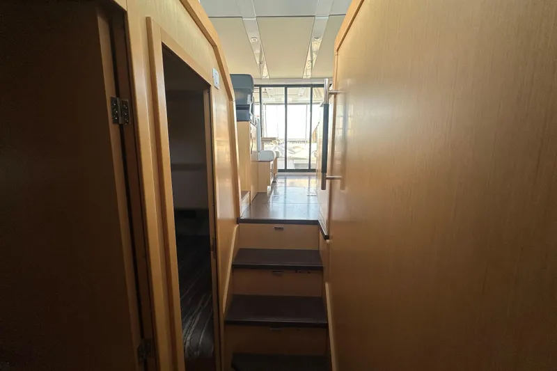 Couples Therapy Yacht Photos Pics Interior view of 2014 Jeanneau Velasco 43 yacht, featuring wooden stairs and modern design.