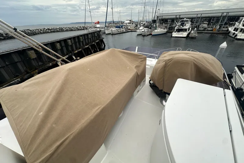 Couples Therapy Yacht Photos Pics 2014 Jeanneau Velasco 43 yacht docked at marina, covered equipment on deck.