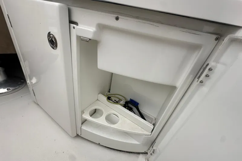 Couples Therapy Yacht Photos Pics Open storage compartment on 2014 Jeanneau Velasco 43 boat with cleaning supplies.