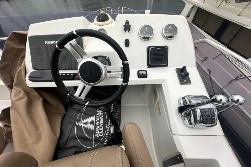Couples Therapy Yacht Photos Pics Helm of 2014 Jeanneau Velasco 43 with steering wheel and navigation controls.