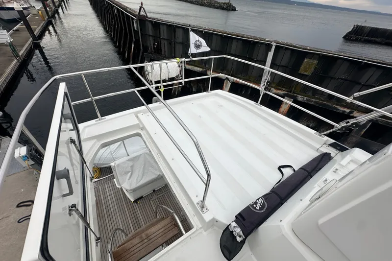 Couples Therapy Yacht Photos Pics 2014 Jeanneau Velasco 43 yacht deck view at marina, showcasing spacious layout.