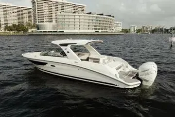  Yacht Photos Pics 2023 Sea Ray SLX 350 Outboard boat on water near urban buildings.