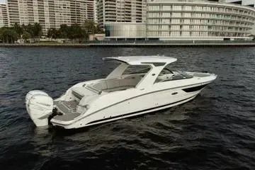  Yacht Photos Pics 2023 Sea Ray SLX 350 Outboard boat on water, cityscape background.