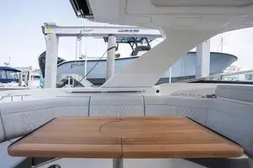  Yacht Photos Pics 2023 Sea Ray SLX 350 Outboard interior with elegant wooden table and seating.