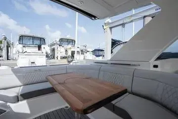  Yacht Photos Pics 2023 Sea Ray SLX 350 Outboard interior with seating and table, docked at marina.