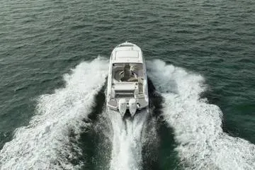  Yacht Photos Pics 2023 Sea Ray SLX 350 Outboard cruising on open water, rear view.