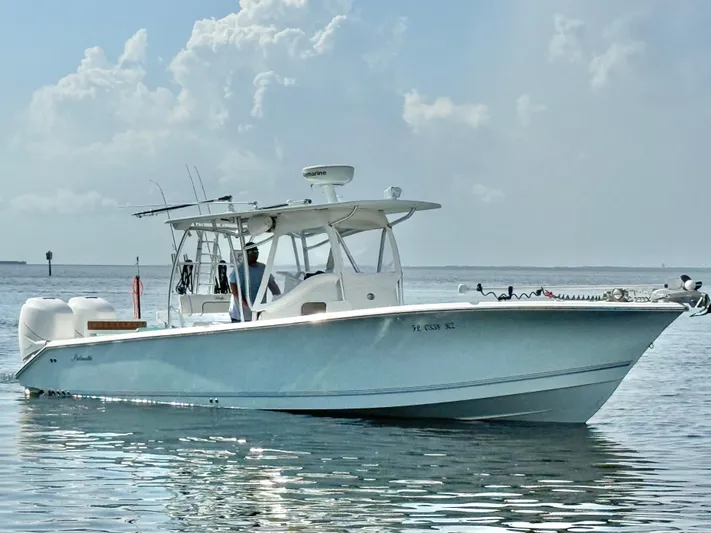  Yacht Photos Pics 2007 Palmetto 33 Custom boat on calm water under a cloudy sky.