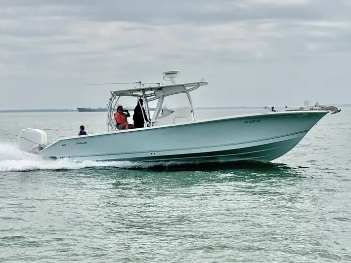  Yacht Photos Pics 2007 Palmetto 33 Custom boat cruising on calm waters under cloudy skies.