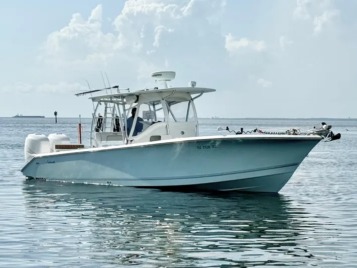  Yacht Photos Pics 2007 Palmetto 33 Custom boat on calm water under a cloudy sky.