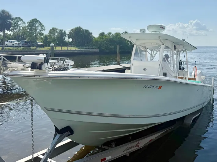  Yacht Photos Pics 2007 Palmetto 33 Custom boat docked on a sunny day, surrounded by trees and water.