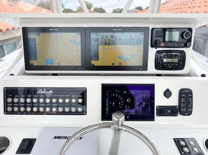  Yacht Photos Pics Control panel of a 2007 Palmetto 33 Custom boat with navigation screens and controls.