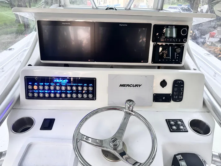  Yacht Photos Pics 2007 Palmetto 33 Custom boat dashboard with Raymarine displays and Mercury controls.