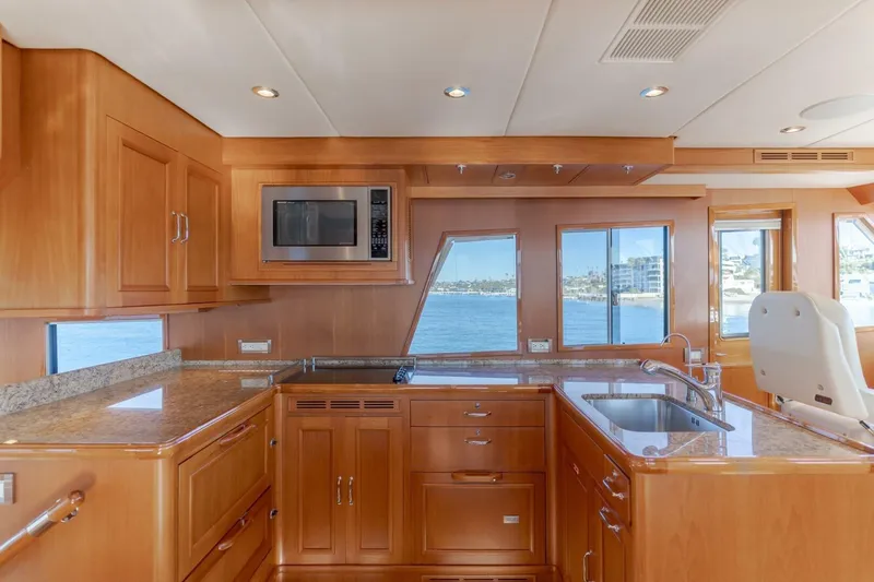 Tintagel Yacht Photos Pics Luxurious kitchen interior of 2008 Grand Banks 59 Aleutian RP yacht with ocean view.