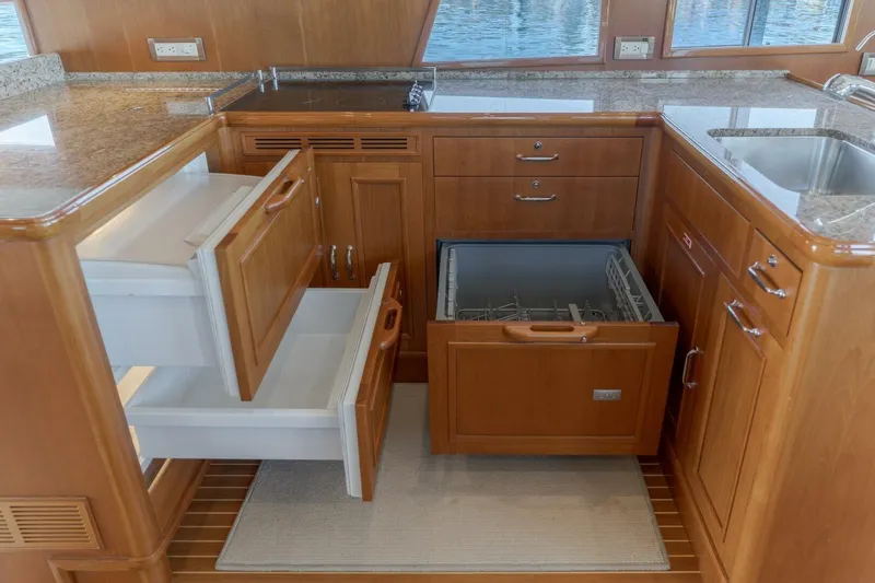 Tintagel Yacht Photos Pics Luxurious 2008 Grand Banks 59 Aleutian RP yacht kitchen with open drawers and dishwasher.