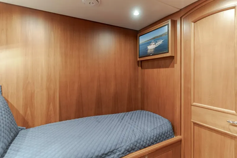 Tintagel Yacht Photos Pics Cozy cabin interior of 2008 Grand Banks 59 Aleutian RP with wood paneling and framed artwork.