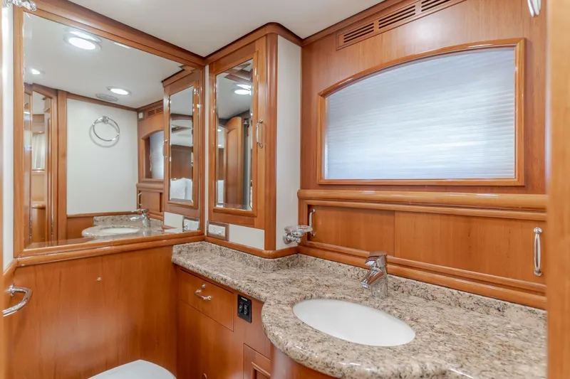Tintagel Yacht Photos Pics Luxurious bathroom interior of 2008 Grand Banks 59 Aleutian RP yacht with wood cabinetry and granite countertop.