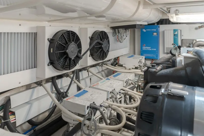 Tintagel Yacht Photos Pics Engine room of 2008 Grand Banks 59 Aleutian RP with battery chargers and cooling fans.